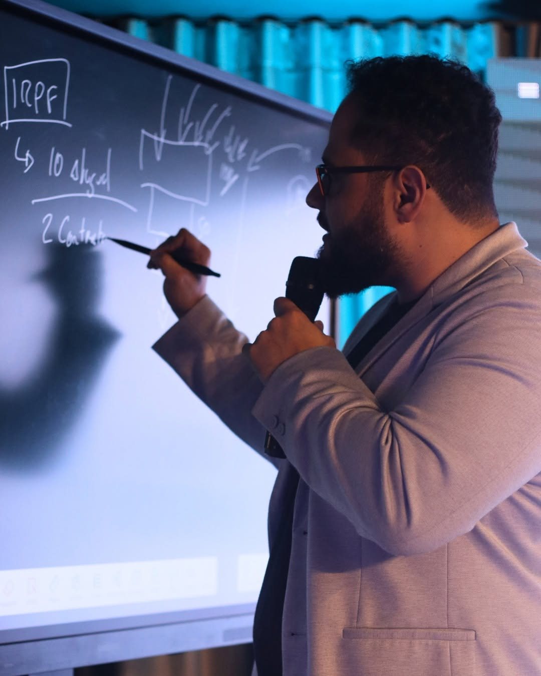 Fernando explicando no quadro branco durante workshop